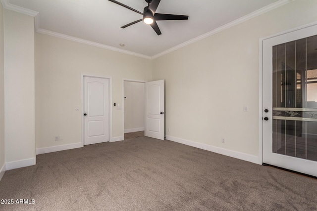 carpeted spare room with ceiling fan and crown molding