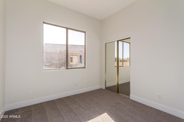 unfurnished bedroom featuring carpet flooring and a closet