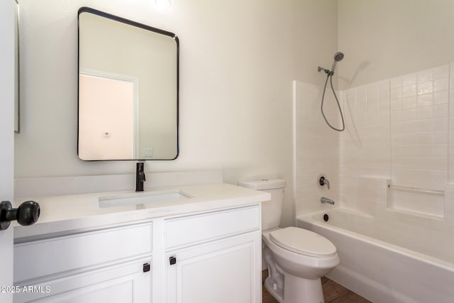 full bathroom with hardwood / wood-style flooring, toilet, vanity, and washtub / shower combination