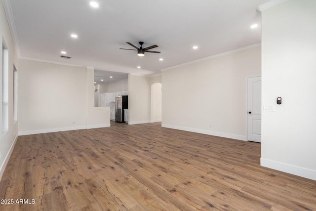 unfurnished living room featuring crown molding, ceiling fan, and light wood-type flooring