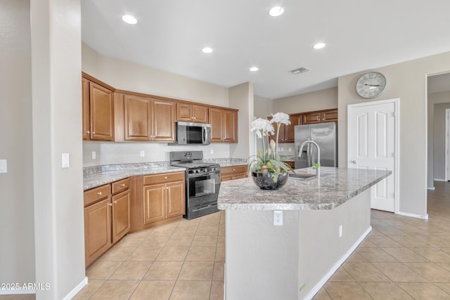 7580 W Darrel Rd, Laveen, AZ 85339 - kitchen with stainless steel appliances, light tile patterned floors, a kitchen island with sink, recessed lighting, and a sink