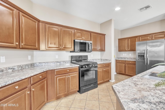 7580 W Darrel Rd, Laveen, AZ 85339 - kitchen with stainless steel appliances, brown cabinets, light tile patterned flooring, recessed lighting, and a sink