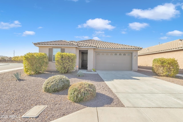 7580 W Darrel Rd, Laveen, AZ 85339 - view of front of home with an attached garage, stucco siding, driveway, and a tiled roof