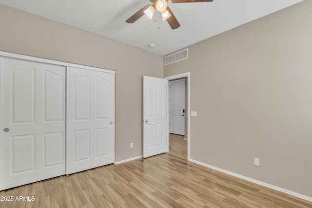 7580 W Darrel Rd, Laveen, AZ 85339 - unfurnished bedroom with light wood-style flooring, baseboards, a closet, and a ceiling fan