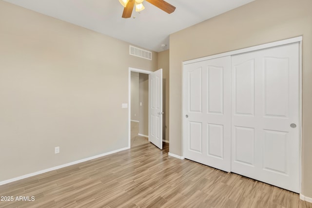 7580 W Darrel Rd, Laveen, AZ 85339 - unfurnished bedroom with light wood-style flooring, a closet, baseboards, and ceiling fan