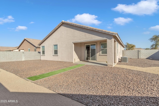 7580 W Darrel Rd, Laveen, AZ 85339 - back of house with stucco siding, a fenced backyard, central air condition unit, and a patio