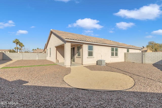 7580 W Darrel Rd, Laveen, AZ 85339 - back of property with stucco siding, a tiled roof, a fenced backyard, and a patio area