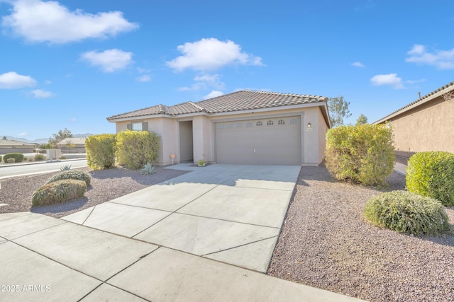 7580 W Darrel Rd, Laveen, AZ 85339 - view of front of house featuring a tiled roof, a garage, stucco siding, and concrete driveway