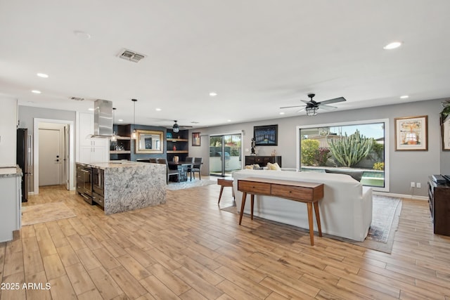 8730 E Montecito Ave, Scottsdale, AZ 85251 - living room featuring ceiling fan, light wood finished floors, recessed lighting, and visible vents