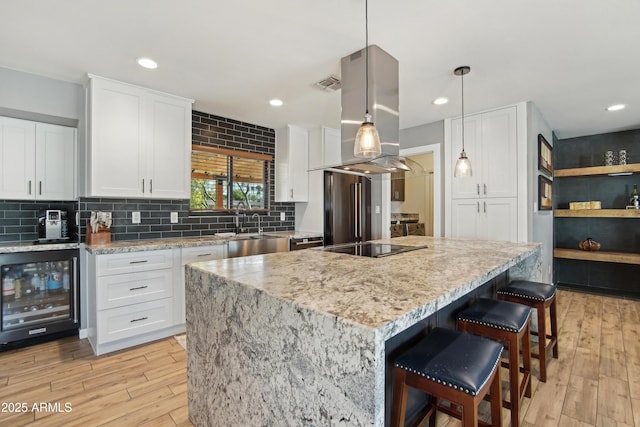8730 E Montecito Ave, Scottsdale, AZ 85251 - kitchen with island range hood, visible vents, a sink, white cabinets, and wine cooler
