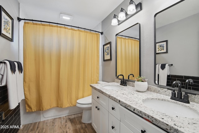 8730 E Montecito Ave, Scottsdale, AZ 85251 - full bath with a sink, double vanity, toilet, and wood finished floors