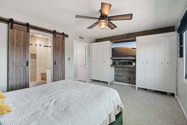 8730 E Montecito Ave, Scottsdale, AZ 85251 - carpeted bedroom with a barn door, two closets, a ceiling fan, baseboards, and visible vents