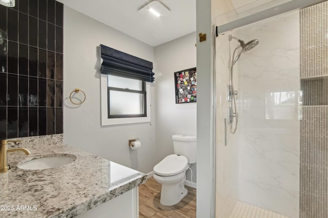 8730 E Montecito Ave, Scottsdale, AZ 85251 - bathroom with vanity, toilet, baseboards, wood finished floors, and a stall shower