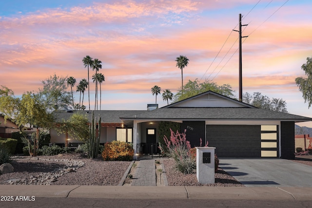 8730 E Montecito Ave, Scottsdale, AZ 85251 - view of front of property with roof with shingles, an attached garage, and driveway
