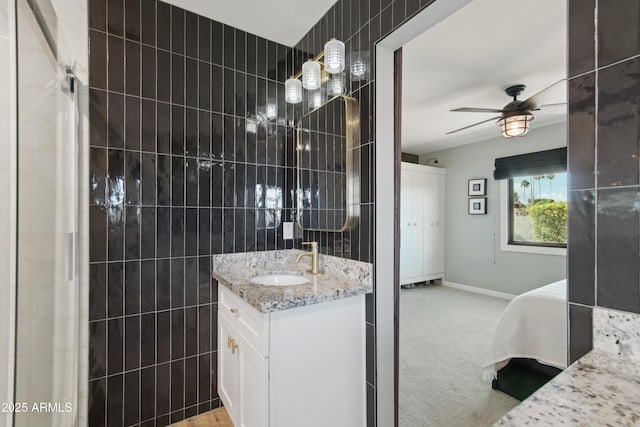 8730 E Montecito Ave, Scottsdale, AZ 85251 - bathroom with tile walls, ceiling fan, baseboards, and vanity