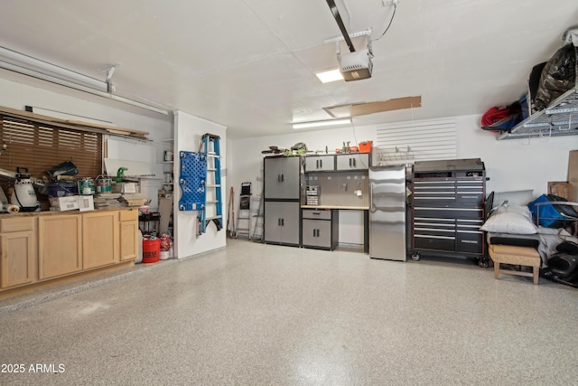 8730 E Montecito Ave, Scottsdale, AZ 85251 - garage featuring a garage door opener and freestanding refrigerator