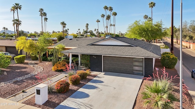8730 E Montecito Ave, Scottsdale, AZ 85251 - ranch-style home with an attached garage, a shingled roof, and concrete driveway