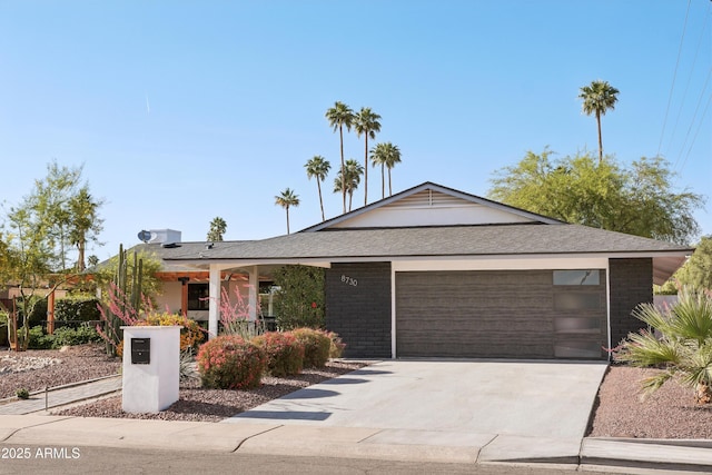 8730 E Montecito Ave, Scottsdale, AZ 85251 - ranch-style house with concrete driveway, brick siding, and a garage