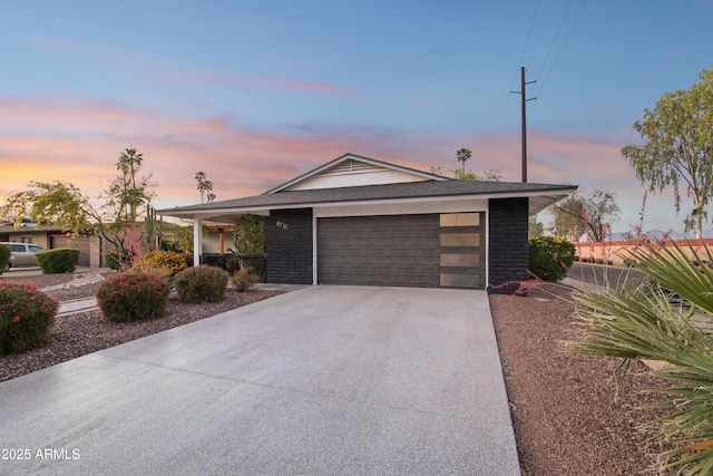 8730 E Montecito Ave, Scottsdale, AZ 85251 - ranch-style house featuring an attached garage, driveway, and brick siding