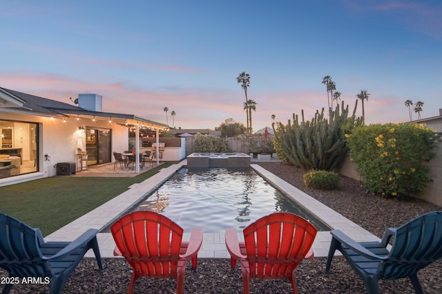 8730 E Montecito Ave, Scottsdale, AZ 85251 - pool at dusk with a patio, a fenced backyard, a lawn, and a fenced in pool