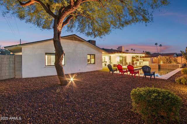 8730 E Montecito Ave, Scottsdale, AZ 85251 - back of house with fence, a patio area, and stucco siding