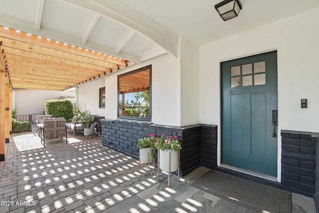 8730 E Montecito Ave, Scottsdale, AZ 85251 - doorway to property with a patio, stucco siding, and an outdoor living space