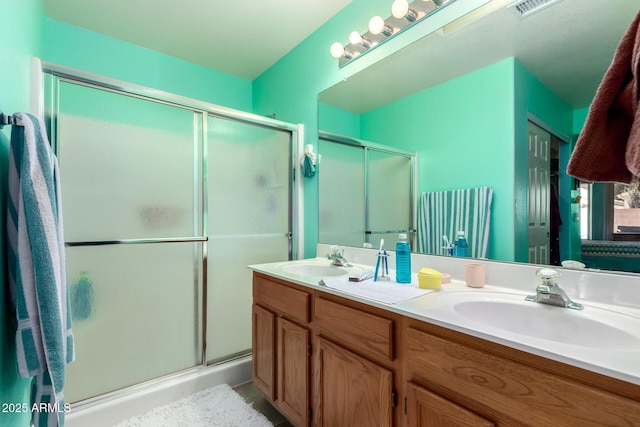 bathroom featuring vanity and an enclosed shower