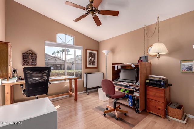 home office with lofted ceiling, ceiling fan, and light hardwood / wood-style flooring