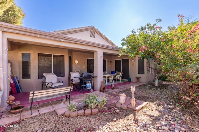 rear view of property featuring a patio