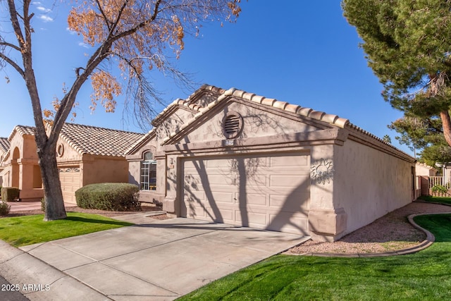 view of front of home with a garage and a front lawn