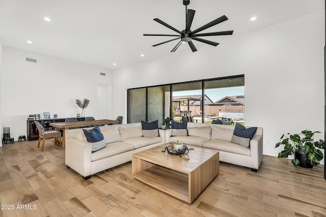 20716 E Pummelos Rd, Queen Creek, AZ 85142 - living area featuring a ceiling fan, recessed lighting, a towering ceiling, and light wood-style floors