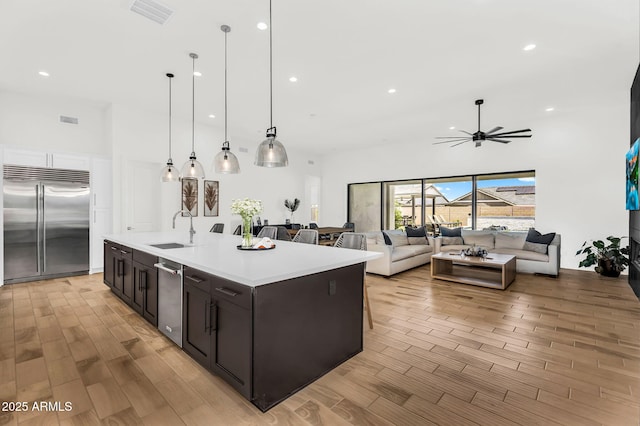 20716 E Pummelos Rd, Queen Creek, AZ 85142 - kitchen with stainless steel appliances, a ceiling fan, light countertops, light wood-style floors, and recessed lighting