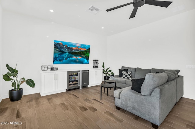 20716 E Pummelos Rd, Queen Creek, AZ 85142 - living area featuring wine cooler, wood finished floors, ceiling fan, and recessed lighting