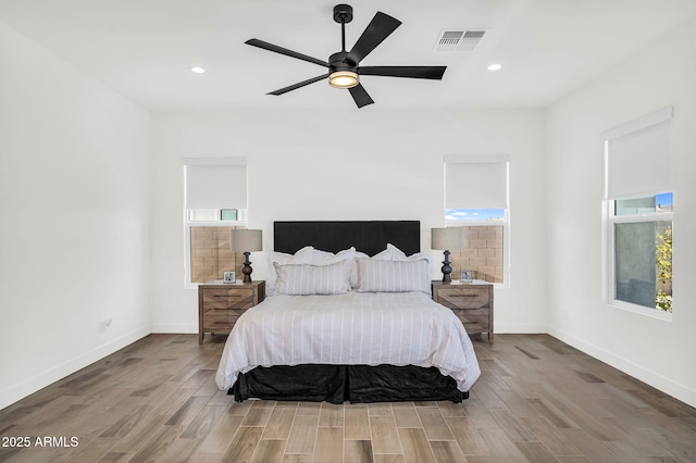 20716 E Pummelos Rd, Queen Creek, AZ 85142 - bedroom featuring multiple windows, wood finished floors, recessed lighting, and a ceiling fan