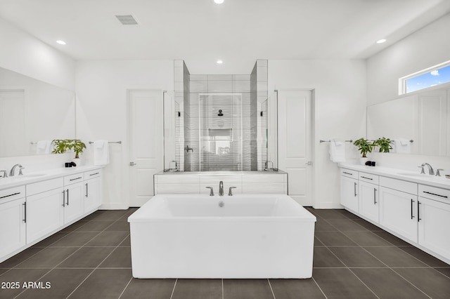 20716 E Pummelos Rd, Queen Creek, AZ 85142 - full bathroom with tile patterned flooring, a stall shower, two vanities, and recessed lighting