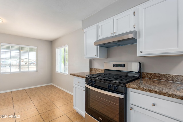 kitchen with gas range, light tile patterned floors, and white cabinetry