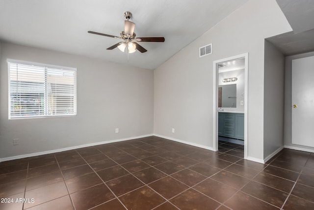 tiled spare room featuring ceiling fan and vaulted ceiling