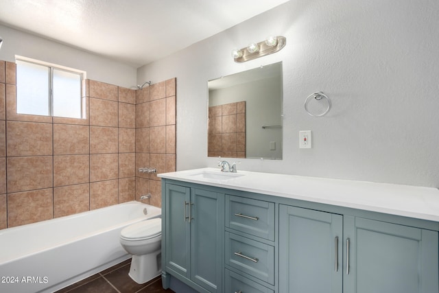 full bathroom with vanity, tiled shower / bath combo, toilet, and tile patterned flooring