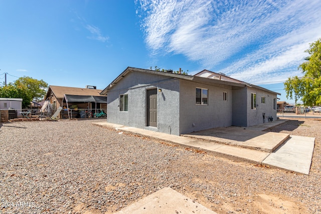 back of house with a patio