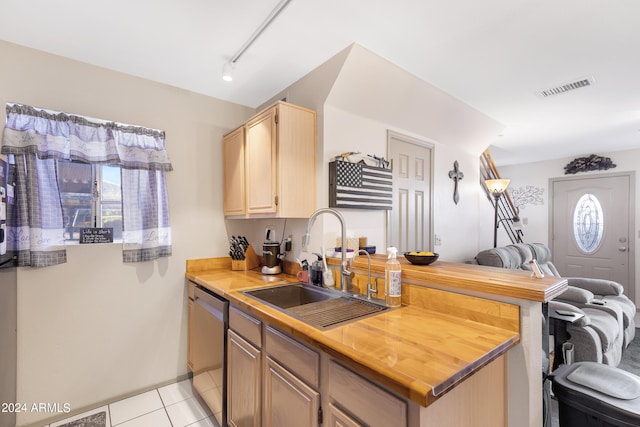 kitchen featuring light tile patterned floors, dishwasher, plenty of natural light, and sink