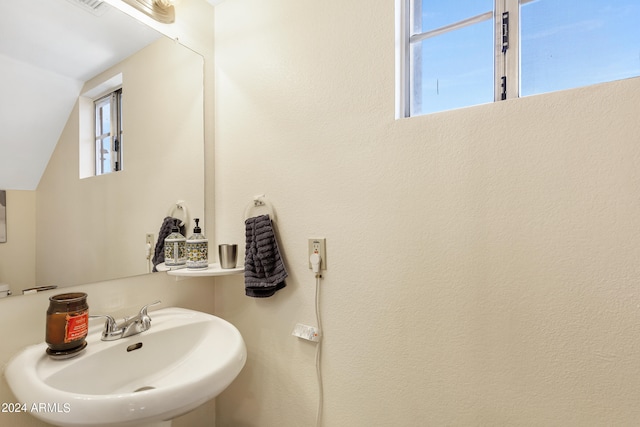 bathroom featuring vaulted ceiling and sink