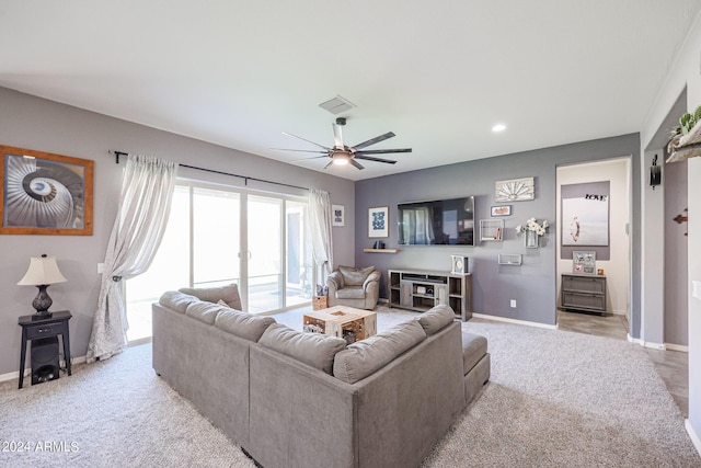 carpeted living room with ceiling fan