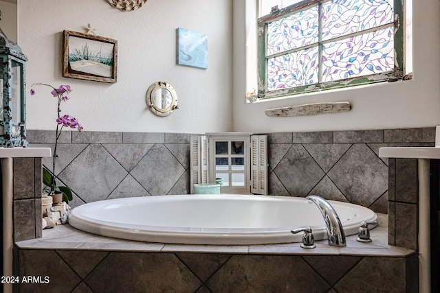 bathroom with tiled bath