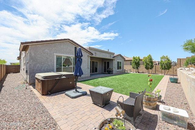 back of house with a patio area and a hot tub