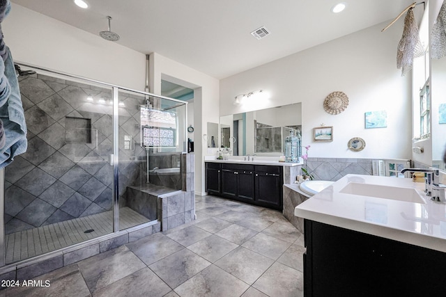 bathroom featuring vanity, tile patterned floors, and separate shower and tub