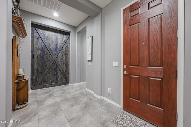 foyer entrance with light tile patterned floors