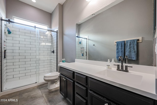 bathroom with toilet, an enclosed shower, and vanity