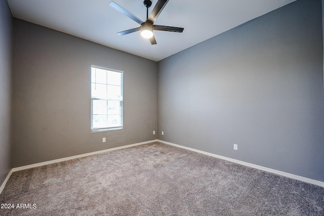 carpeted empty room featuring ceiling fan