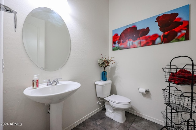 bathroom with toilet and tile patterned flooring