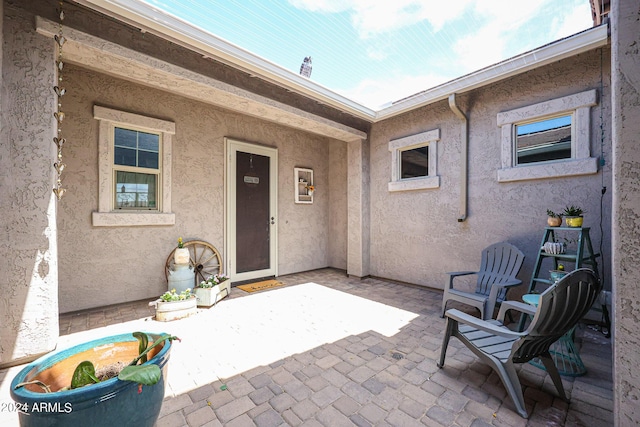 property entrance featuring a patio area